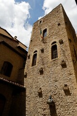 Stone tower with Italian flag and blue sky