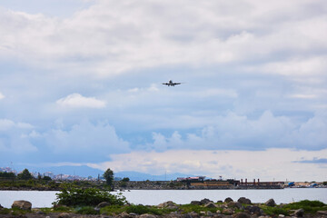 The plane is coming in to land over the city. International passenger transportation.