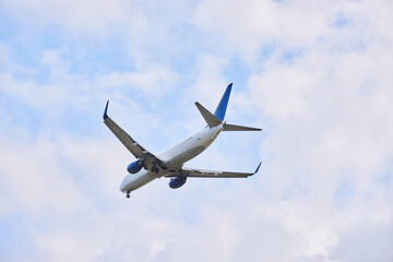 The plane is in the air against the blue sky. Close-up of the aircraft