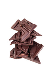 Pile of bitter dark chocolate pieces isolated on a white background