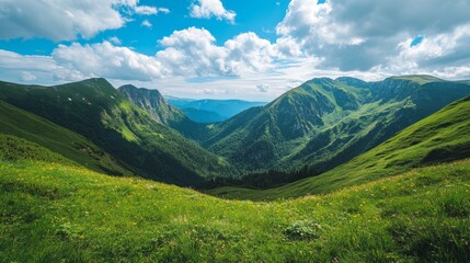 Obraz premium Lush Green Mountain Landscape Under Blue Sky with Fluffy Clouds