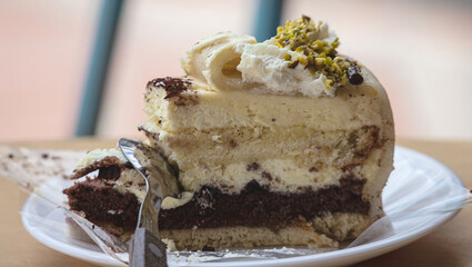 piece of sponge cake with cream and a spoon