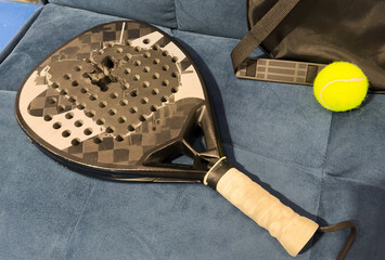 Padel tennis racket. Background with copy space. Sport court and balls.