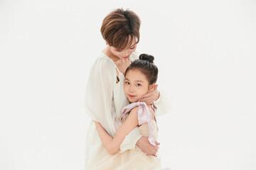 Beautiful mother and cute daughter portrait on white background