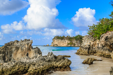 A rocky beach with a blue ocean in the background