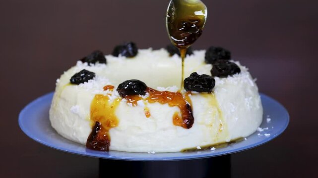 Traditional Brazilian coconut flan dessert known as manjar branco, manjar de coco and manjar dos deuses. Served with plum syrup.