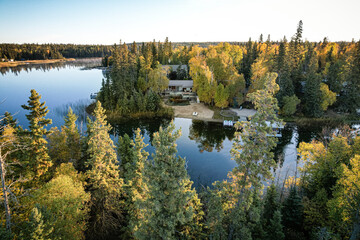 A beautiful lake surrounded by trees and a house