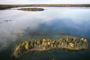 A small island with trees and a lake in the background