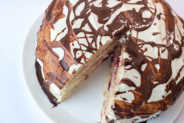 Chocolate pie Milchmadchen with cheese cream sauce with banana and cherry on the white background....