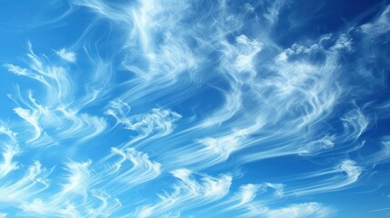 Fototapeta premium Blue sky with white wispy clouds, creating a soft and ethereal background.