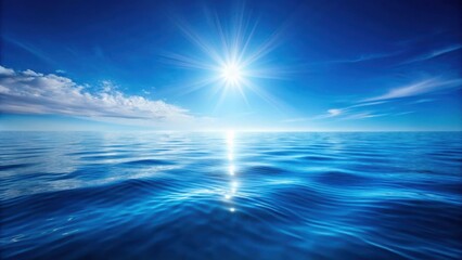 Obraz premium A serene seascape featuring a brilliant sun shining through wispy clouds, casting shimmering reflections on the gently rippling ocean surface.