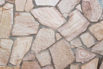 A background of a granite mosaic wall in pastel shades