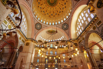 Obraz premium interior of mosque, domes are painted with patterns, decorative windows and columns, chandeliers, beautiful architecture of Islamic religion, Istanbul, Turkey