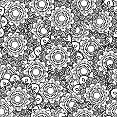 Hand drawn seamless pattern with leaves and flowers. Doodles floral ornament. Black and white decorative elements. Perfect for wallpaper, adult coloring books, web page background, surface textures.