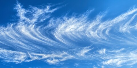 A Captivating Celestial Dance: Delicate Cloud Formations Against a Vibrant Blue Sky