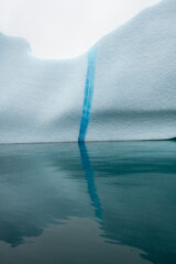 White rock covered with ice by water