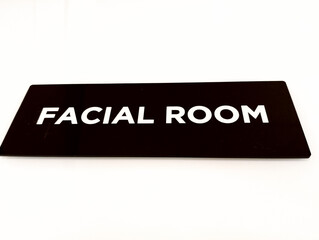 a close up of a black rectangular sign with the words 