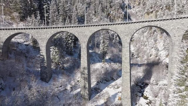 Snowy landscape at Schmitten Albula with Schmittentobel Viaduct in the Swiss Alps on a snowy autumn day. Movie shot November 22nd, 2024, Filisur Albula, Switzerland.
