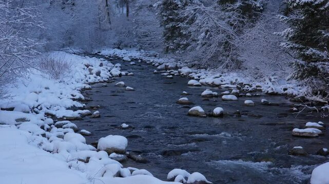 Snowy landscape at Schmitten Albula with Schmittenerbach river in the Swiss Alps on a snowy autumn day. Movie shot November 22nd, 2024, Schmitten Albula, Switzerland.