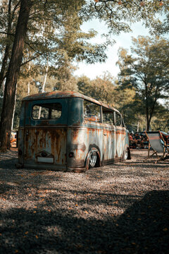 A vintage DKW Schnellaster van with a rustic patina and lowered stance, parked on gravel at a car exhibition. Perfect for themes of classic automotive design, restoration, and retro charm.