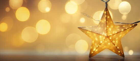 Golden star decoration on a warm yellow bokeh background for festive Christmas celebrations and decor inspiration