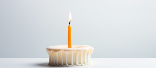Birthday candle in the shape of a number atop a plain white background for celebrations and special occasions.