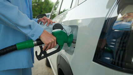 Unknown Caucasian woman driver businesswoman female car buyer girl lady refuel automobile tank auto...