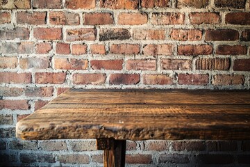 A simple wooden table placed in front of a brick wall, suitable for home office or studio use