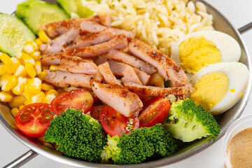 angle view healthy meal with pork and cucumber and eggs and broccoli and maize and cherry tomatoes and mangoes horizontal composition