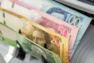 Peru money. Money counting machine with Peruvian soles. Business concept. Financial operations in...