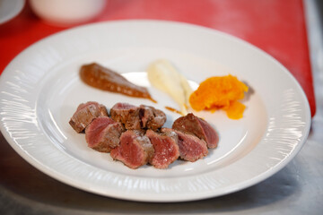 Ready to be eat, plate of cooked meat with sauces in side