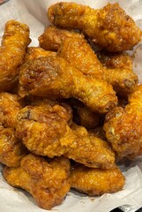 A box of Korean fried chicken with special Korean seasoning. Some pieces come with spicy sauce. Crispy and delicious.
