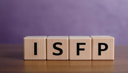 Wooden cubes with abbreviation ISFP on table. Introverted, Sensing, Feeling, Perceiving.
