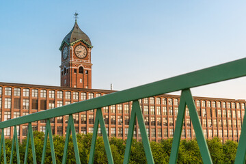 Iconic Ayer Mill clock tower and nineteenth century brick mill building in the historic immigrant city of Lawrence Massachusetts. © Heidi