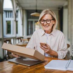 mature woman entrepreneur prepare package for send to customer