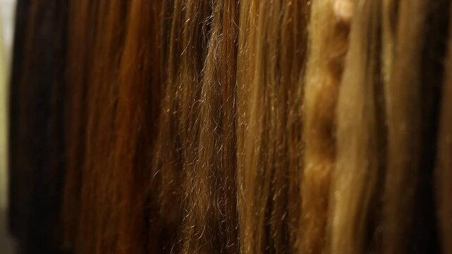 The Hair and Beauty Industry, hairpiece industry. Hair Extension Salon. Long fake hair on a bench in a store. Hair extension business, wig industry, wig business, beauty industry.