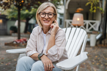 smile woman owner sit in the garden of the restaurant and smile