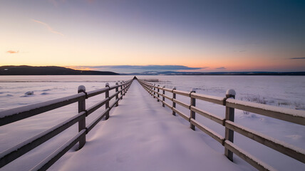 A snow-covered wooden fence stretching into the distance