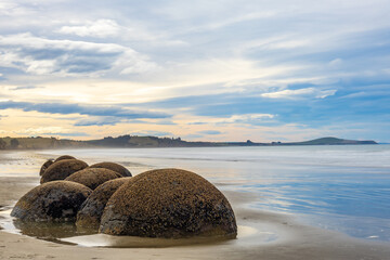 Long exposure shot of Moeraki Boulders in New Zealand. Famous landmark large spherical stones on Koekohe Beach near Moeraki on New Zealand's Otago coast. A popular tourist attraction