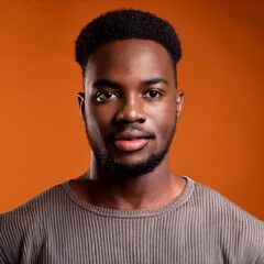 Fototapeta premium close up of handsome American man on orange studio background