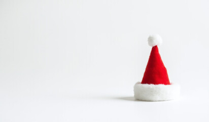 small red santa hat sits alone pristine white backdrop