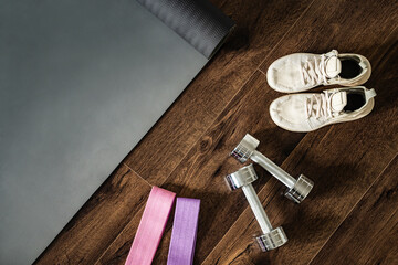 Workout equipment for training at home top view, sneakers, dumbbells, fitness elastic band, sport...