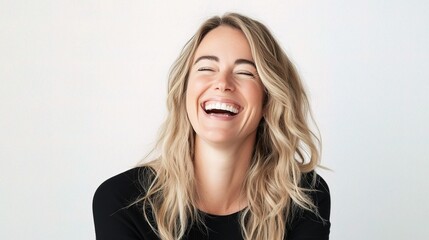 Cheerful Blonde Woman Laughing in a Bright Portrait Setting