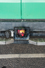 Tiny BMX helmet on the tow bar of a van.
