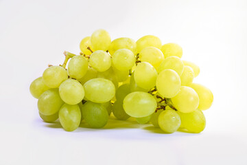 The image shows a close-up of juicy green grapes gathered in a tight bunch. Light green berries with smooth skin look stylish and appetizing.