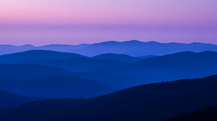 Obraz premium Serene mountain landscape at dusk with soft, layered hues of blue and purple.