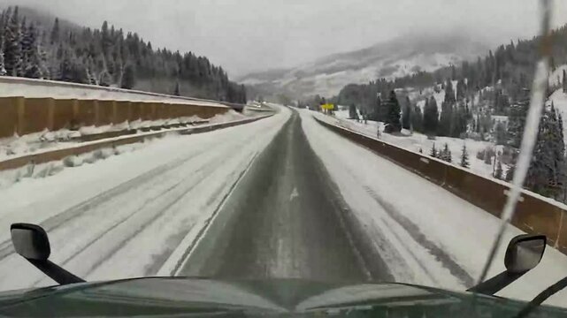 Terrifying Jackknife Truck Crash on Black Ice During Snowy Winter Weather. Captured on snowy highway, truck jackknifing on black ice, highlighting the dangers of winter driving in treacherous weather