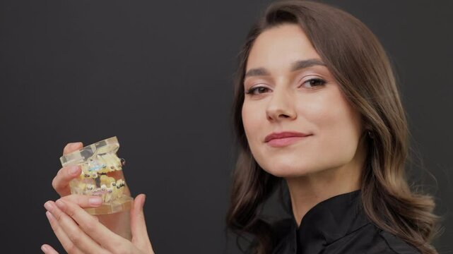 Orthopedic dentist doctor is holding teeth 3d printed model of the patient's jaw with malocclusion