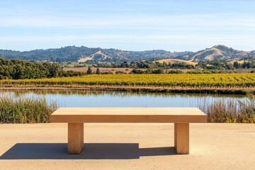 Obraz premium A peaceful roadside stop featuring a bench overlooking a serene lake with apricot orchards in the distance