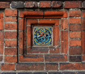 Old decorative glazed ceramic picture ceramic ornament.